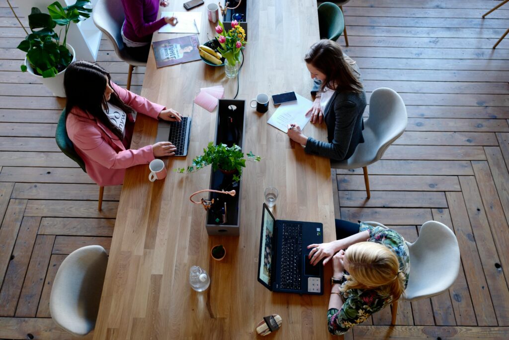 pexels photo 2041627 2041627 Overhead view of diverse women professionals working in a modern office setting, fostering collaboration and teamwork.